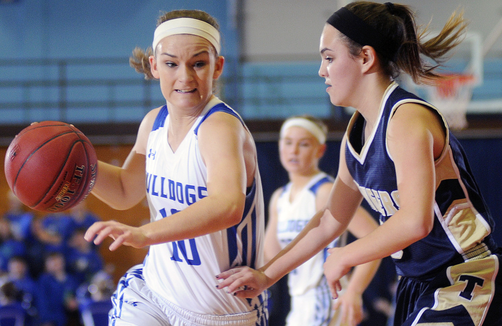 Madison guard Kayla Bess dribbles around Traip’s Jessica Segura during a Class C South quarterfinal Tuesday at the Augusta Civic Center.