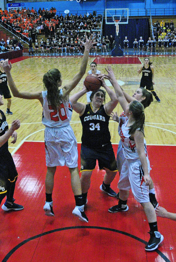 Staff photo by Joe Phelan
Mt. Blue’s Olivia Ryan is swarmed by Gardiner’s Mary Toman, left, Lauren Chadwick and Logan Granholm (14) during a Class A North quarterfinal last Friday in the Augusta Civic Center.