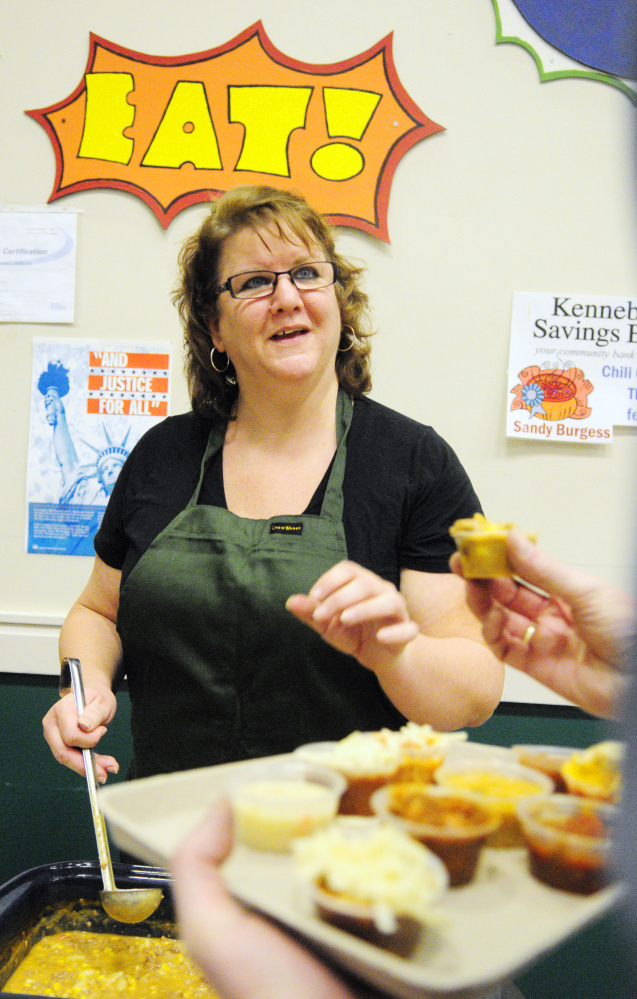 Sandy Burgess tells an attendee about the creamy base vegetable soup with beef she’d made and served during the chili and chowder fundraiser event on Saturday at Winthrop High School.