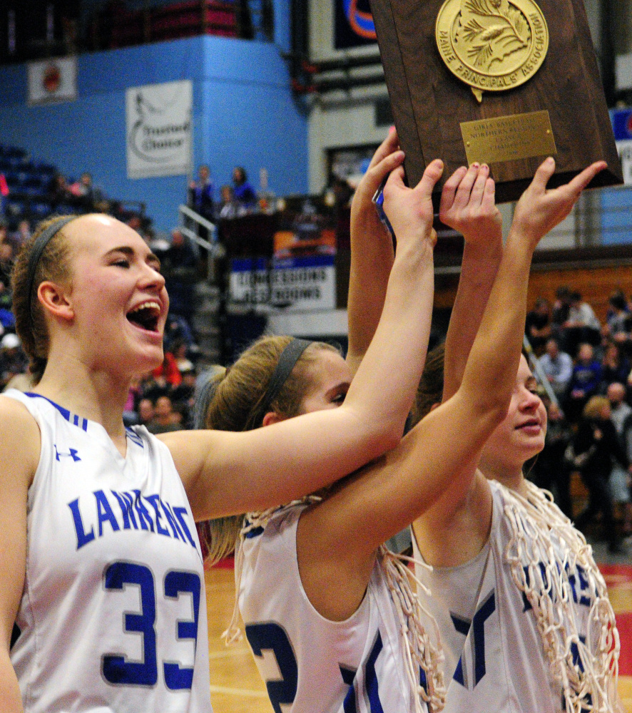 Lawrence captains Nia Irving, left, Dominique Lewis and Morgan Boudreau hold the Class A North championship plaque last Friday at the Augusta Civic Center.