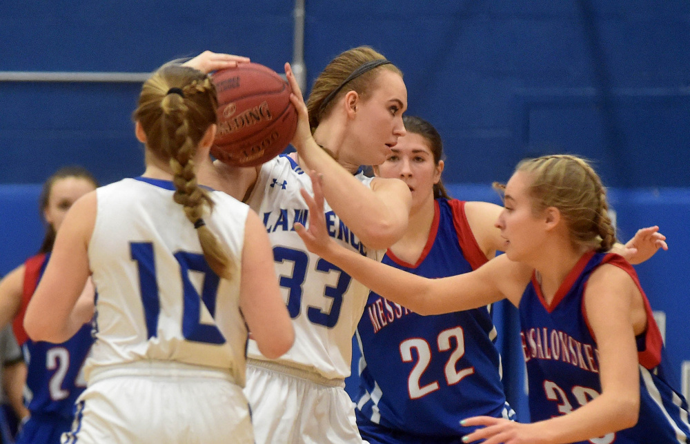 Lawrence senior Nia Irving (33) looks for an opening as Messalonskee’s Ally Turner defends during a game earlier this season in Fairfield.