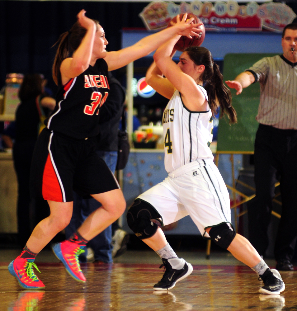 Staff photo by Joe Phelan 
 Shead's Katelyn Mitchell, left, defends Rangeley's Sydney Royce during the Class D state championship game Saturday at theAugusta Civic Center.