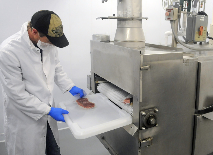 Butcher Moe Howard collects packages of meat that passed through the flash freezer tunnel Monday at Central Maine Meats in Gardiner.