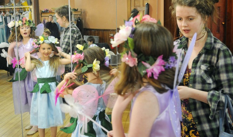 Autumn Jackson, right, helps Athea Trussell, center, and Micah Wolf prepare Tuesday for a curtain call for the home school student performance of Shakespeare’s “A Midsummer Night's Dream” at Cumston Hall in Monmouth.