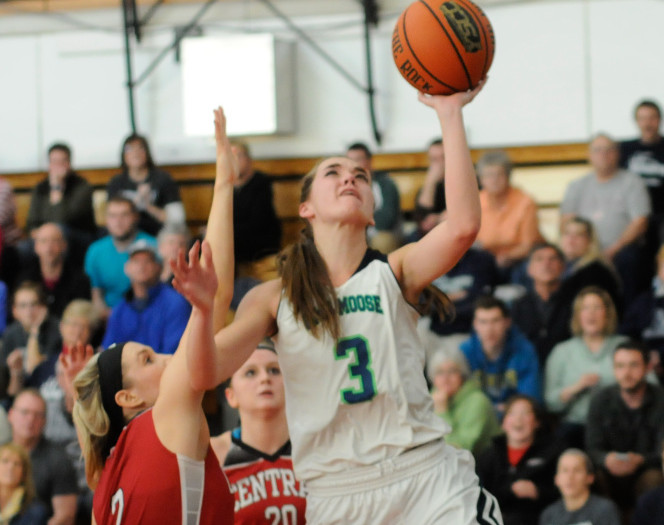 University of Maine at Augusta center Jamie Plummer goes up for a shot during a game against Central Maine Community College earlier this season.