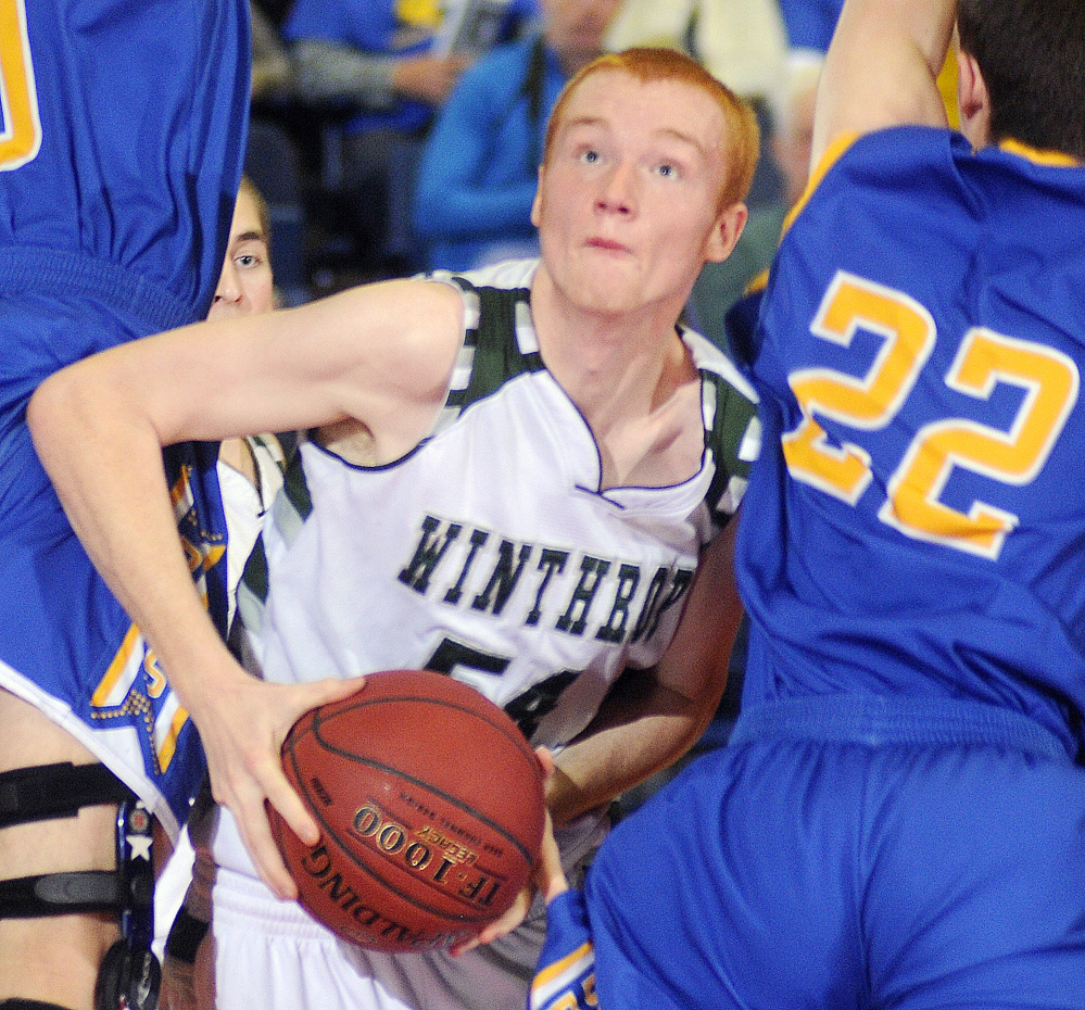 Winthrop High School’s Anthony Owen creates an opening between Boothbay’s Abel Bryer, left, and Jacob Leonard during a Class C South semifinal tournament game at the Augusta Civic Center earlier this season. Owens scored 15 points while playing for the South regional team in the Class C/D boys basketball all-star game on Saturday in Bangor.