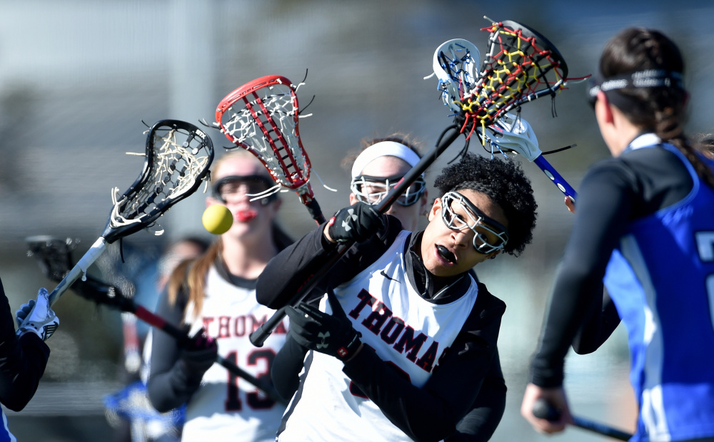 Thomas College’s Jordyn Taylor, front, loses possession of the ball in the second half of a game against St. Joseph’s College on Saturday at Thomas College in Waterville.