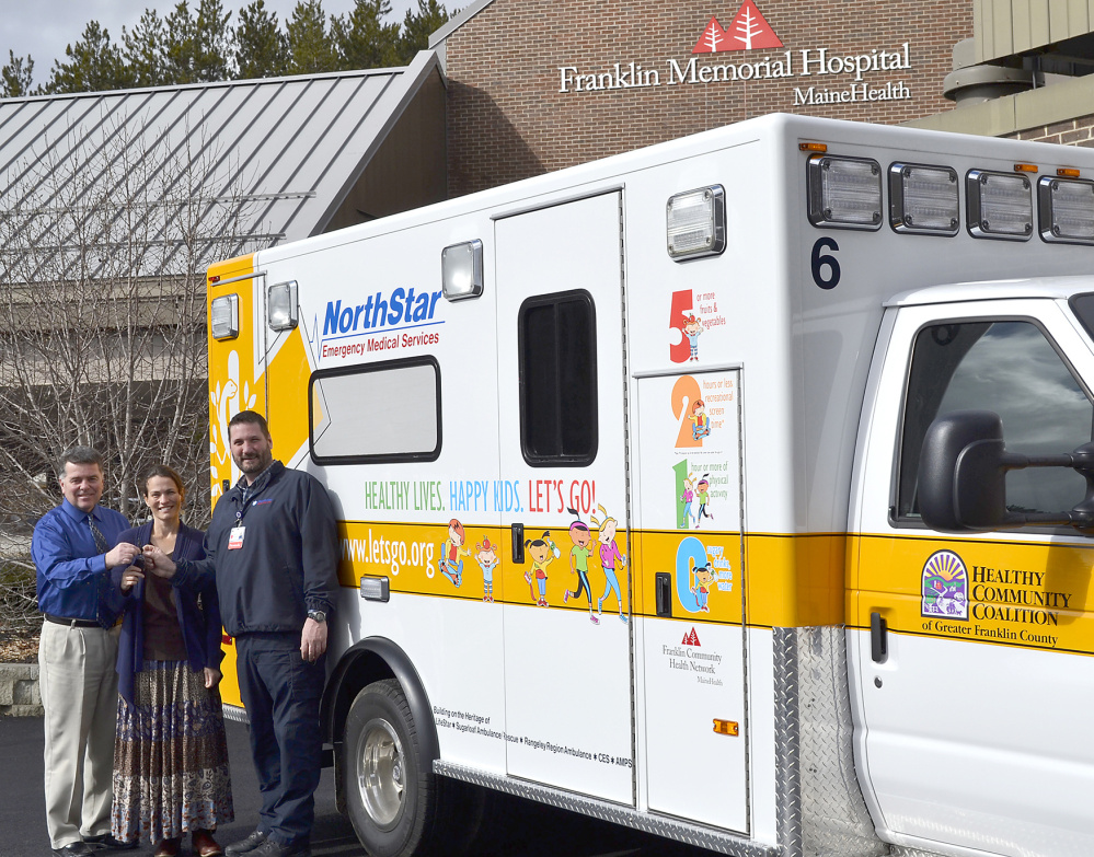 NorthStar EMS in Farmngton unveiled its third health-theme painted ambulance on March 11 to the community — a colorful yellow and white ambulance with images of children promoting the 5-2-1-0 Lets Go! message and adorning the Healthy Community Coalition logo, the organization that administers the Lets Go! program in Greater Franklin County. From left, are Gerald Cayer, executive vice president; Dr. Lorien Batt, lead physician Franklin Health Pediatrics; and Mike Senecal, director NorthStar ambulance.