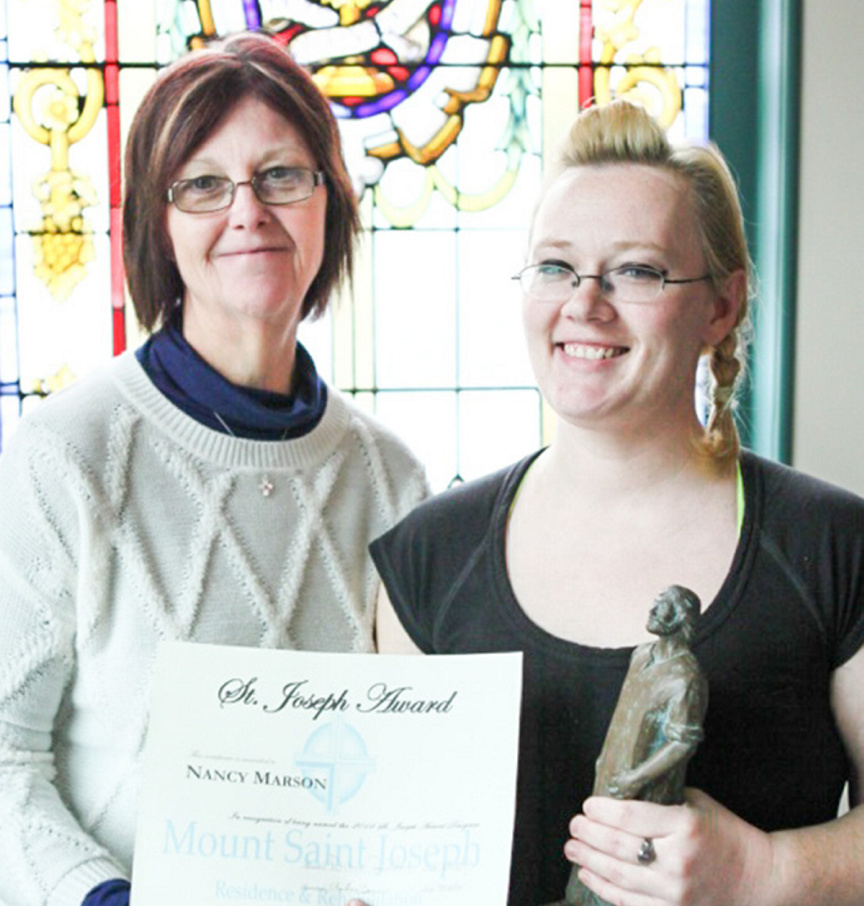 Mount Saint Joseph Administrator Diane Sinclair, left, presents Nancy Marson, of the facilities’ dietary services team, with the annual St. Joseph Award at a recent ceremony at Mount Saint Joseph in Waterville.