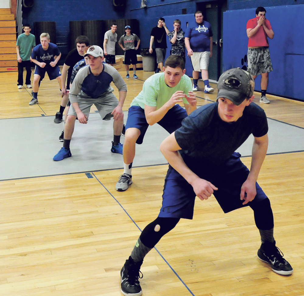 Lawrence High School baseball players take part in drills during practice Monday in Fairfield.