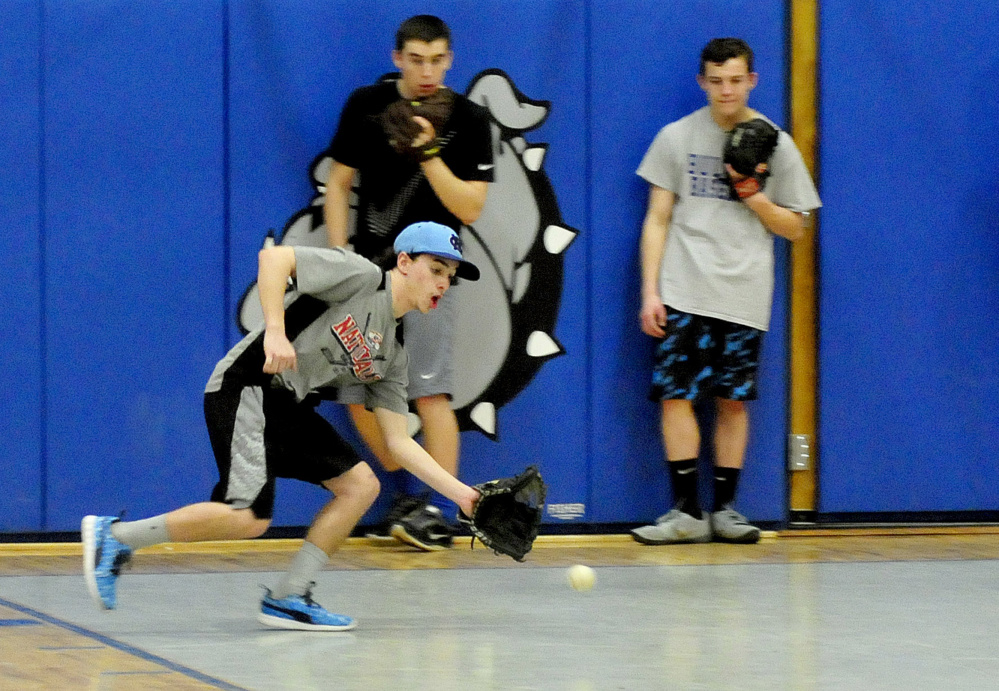 Lawrence’s Gunner Hann fields a line drive during the first practice of the season Monday in Fairfield.