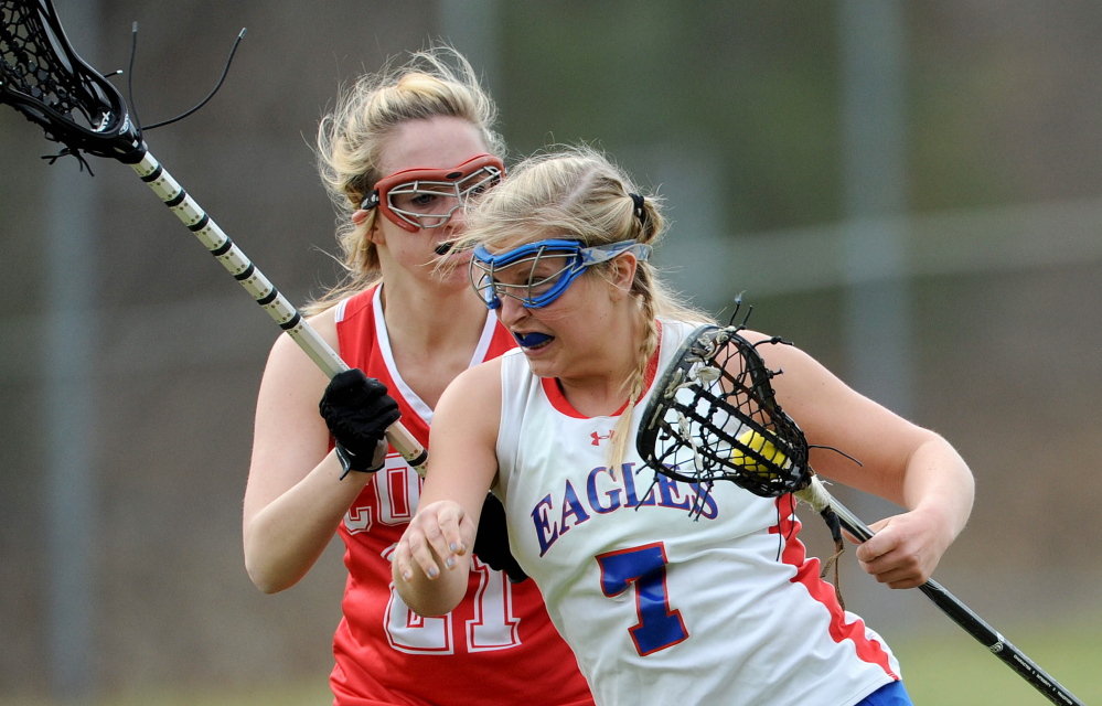 Messalonskee’s Lydia Dexter looks to break away from Cony’s Christina Claudel during a game last fall. Dexter verbally committed to attend the University of Maine.