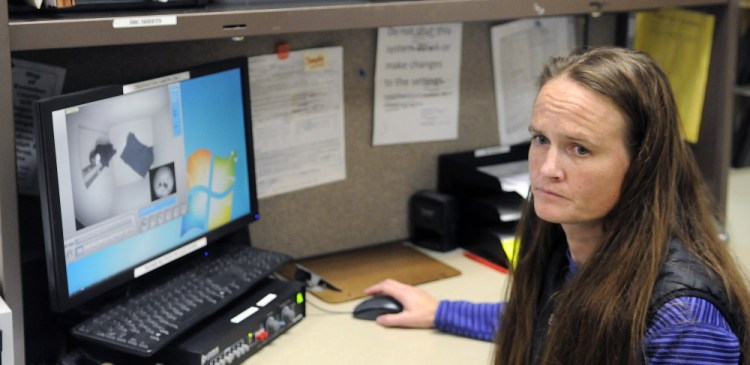 A nurse monitors a patient in the Lower Saco forensic unit on Sept.10, 2014, at the Riverview Psychiatric Center in Augusta through a video camera.