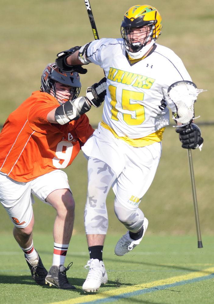 Gardiner Area High School's Jake Folsom, left, tags Maranacook Community High School's Ty Smith during a boys lacrosse game Tuesday in Readfield.