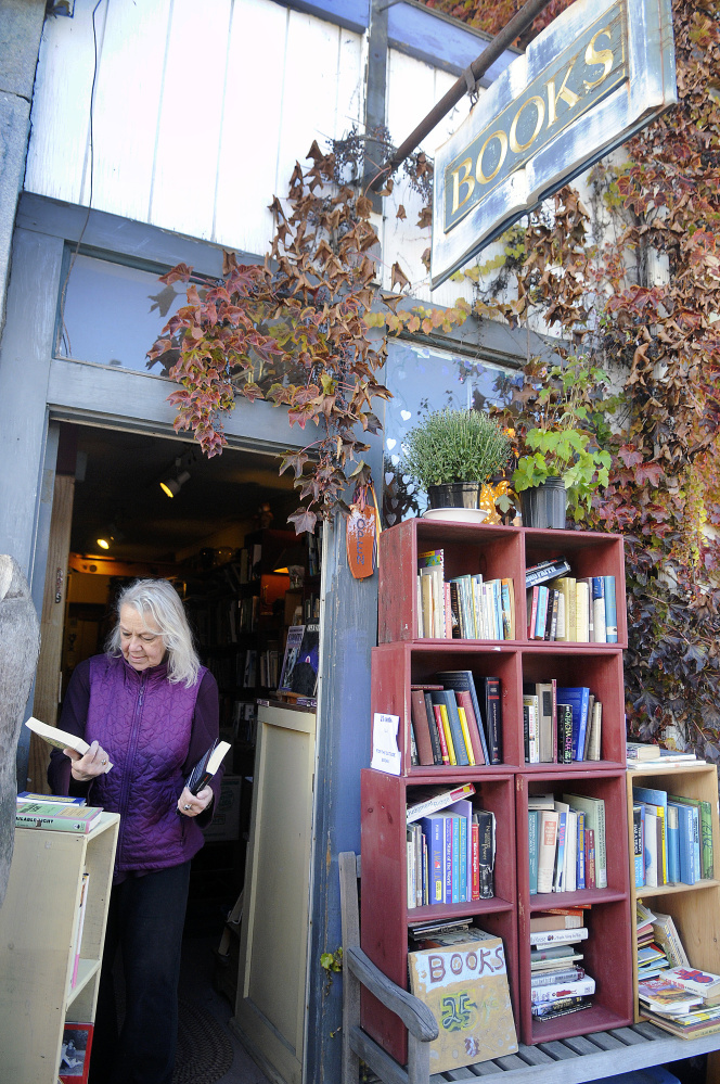 Edda Briggs Thiele sorts titles in October 2015 at RiverBooks in Hallowell, which closed a few days later. The Liberal Cup is asking for permission to move its front door to the old RiverBooks entrance.