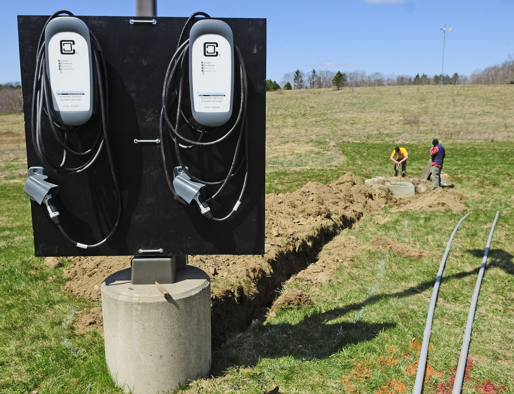 ReVison Energy workers install a pair of electric car chargers Thursday at the Maple Hill Farm Inn and Conference Center in Hallowell, the first inn in the area to provide the service.