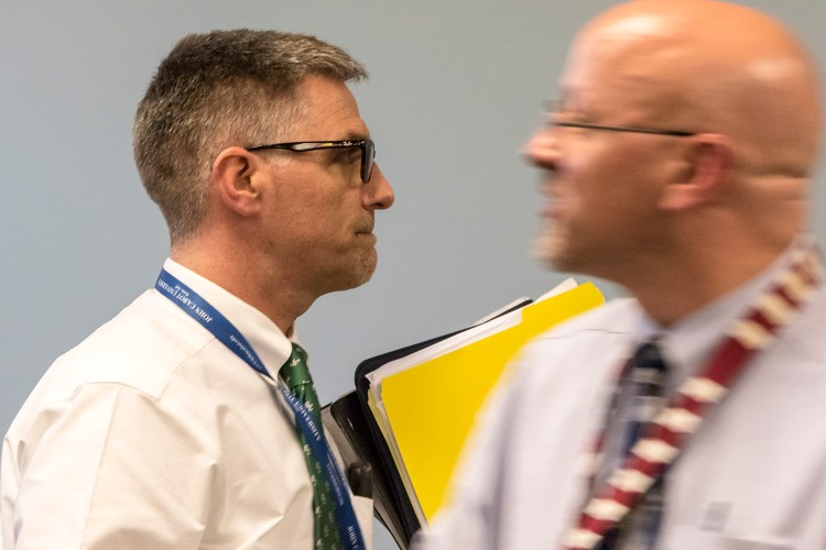 SAD 6 Superintendent Frank Sherburne walks past school board member Daniel Kasprzyk on Tuesday before entering the board's executive session.