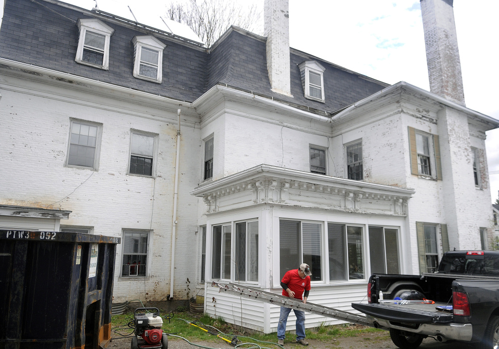 2016 file photo: Volunteer Norm Finish unloads a ladder at the Betsy Ann Ross House of Hope on Wednesday at 8 Summer St. in Augusta. The building is being converted into a shelter and transitional housing for female veterans.