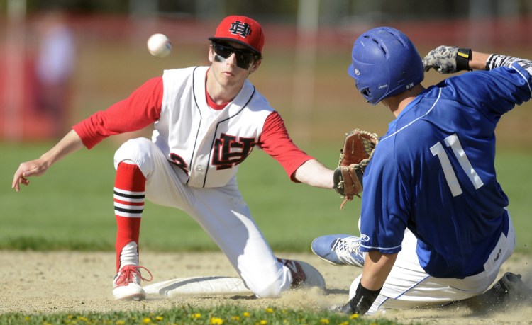 Hall-Dale's Tyler Nadeau, left, can't connect with a throw to second as Madison's Chase Malloy slides in during a game Wednesday in Farmingdale.