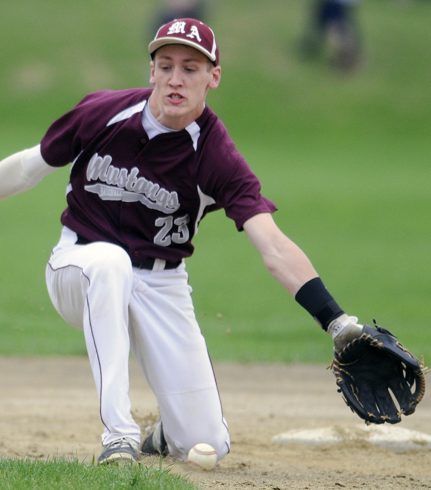 Monmouth Academy's Hunter Richardson tries to collect a grounder during a Mountain Valley Conference game against St. Dominic earlier this season.