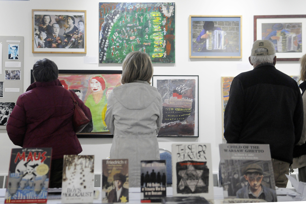 Pieces of art and books on display Monday at the exhibit "Those People … Well, They're Not People at All: Children's Reactions to the Holocaust" displayed in the Holocaust and Human Rights Center of Maine in Augusta.