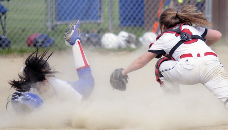 Hall-Dale's Emma Begin can't reach Oak Hill's Jamie Prue at home Monday in Wales.