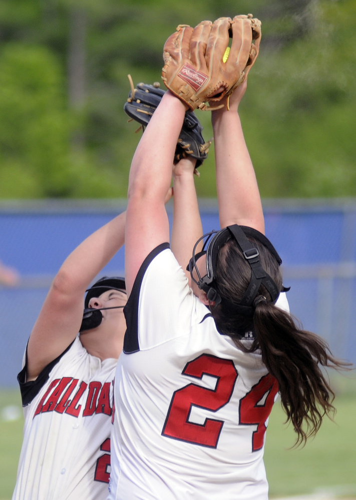 Hall-Dale's Becca Ackerson, left, and Hailey Taker collide while going for a pop up on the mound during a game against Oak Hill on Monday in Wales.