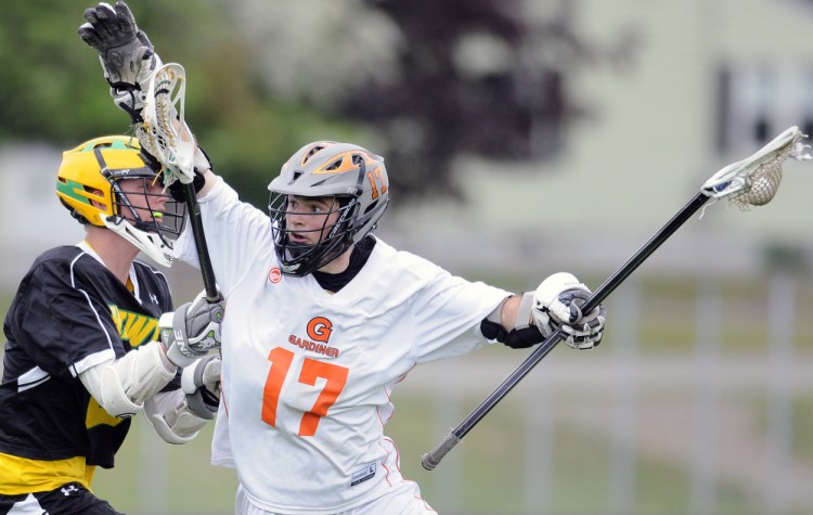 Gardiner's Cam Bell, right, is closely defended by Maranacook's Tyler Nussinow during a lacrosse game Wednesday in Gardiner.