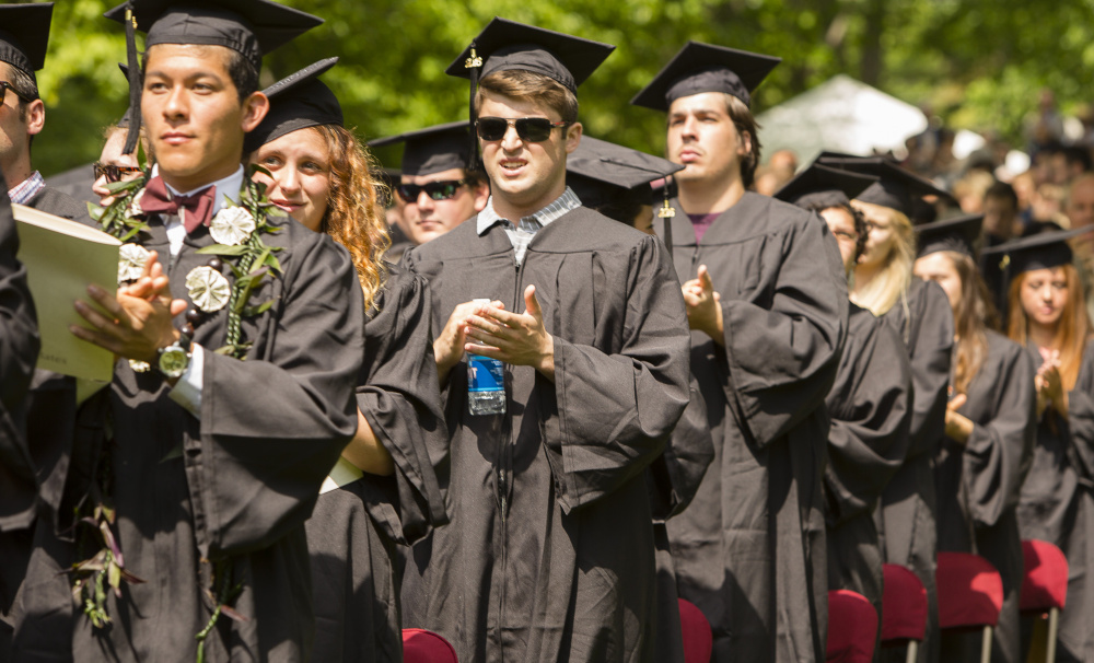 Bates College graduates applaud Rep. Lewis during the commencement ceremony Sunday.