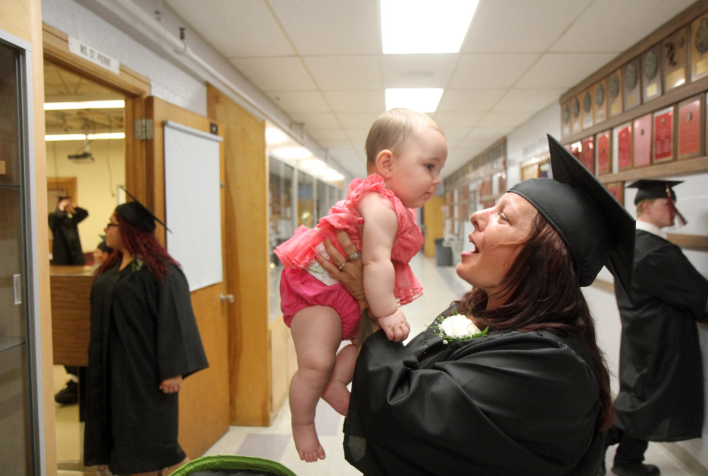 Madelaina Visconti, of Winslow, holds her granddaughter Lilly Ann Tingley before the start of the graduation ceremony Tuesday night at Mid-Maine Regional Adult Community Education at Waterville Senior High School.