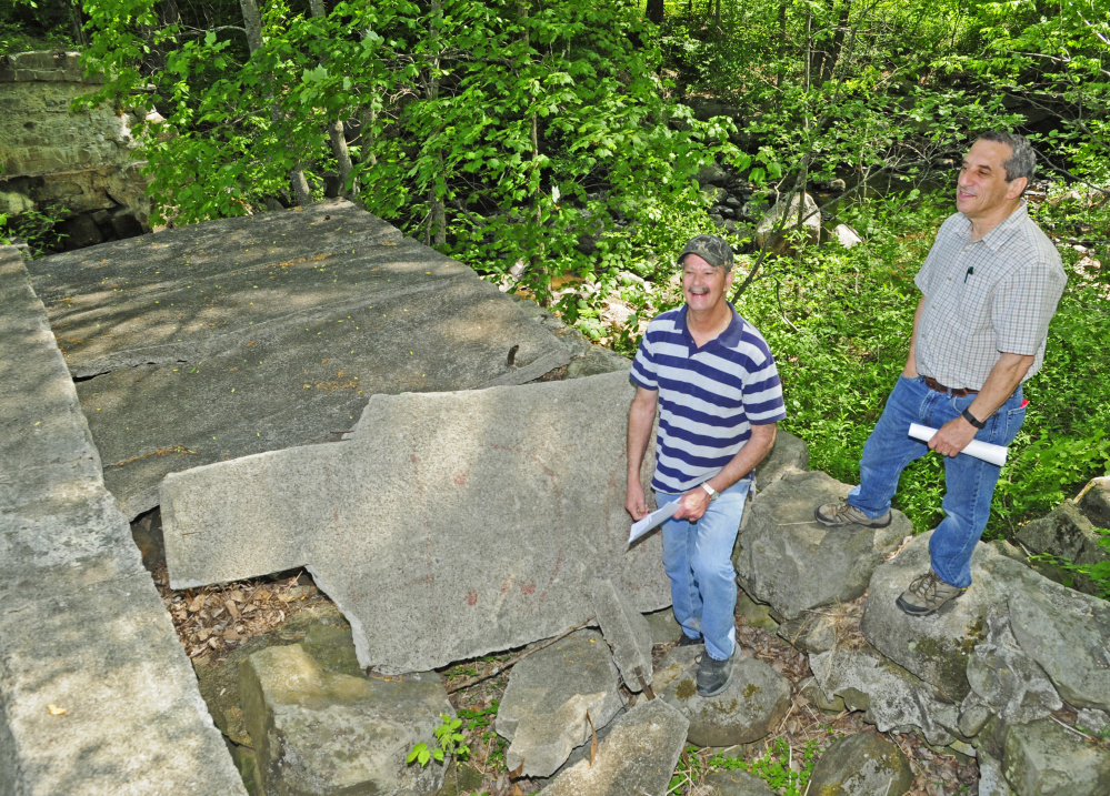 Bob Harris, left, and Jerry Bley stand on top of the washed out dam on Thursday on the Mill Stream in Readfield. They're part of a group planning to renovate the area by adding trails and other improvements aimed at providing greater public access.