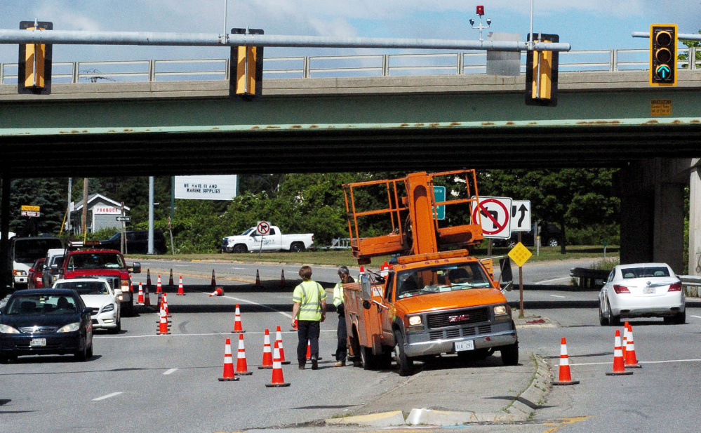 A Waterville Public Works Department truck occupies the middle of Kennedy Memorial Drive in Waterville on Thursday as a power outage afflicts customers in the area. Power was out for about an hour for 687 cutstomers after a tree limb fell and knocked down a power line at 8:47 a.m. on First Rangeway. The public works crew worked through the outage.