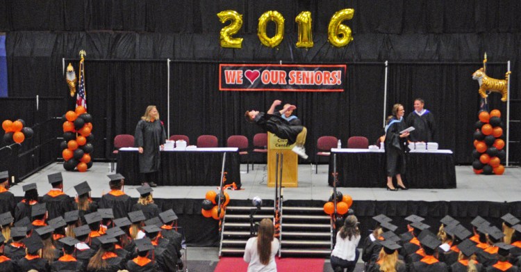 Peter Del Gallo does a back flip Saturday after receiving his diploma during the Gardiner Area High School graduation at the Augusta Civic Center.