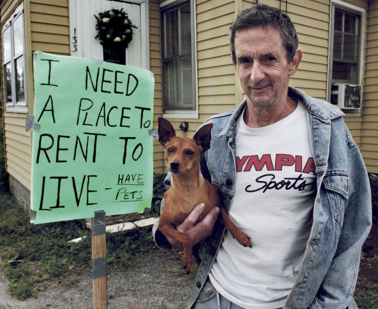 Gary Prentiss with his dog Ginger outside his home in Waterville Thursday. He must be out of the home in less than a month and has nowhere to go.