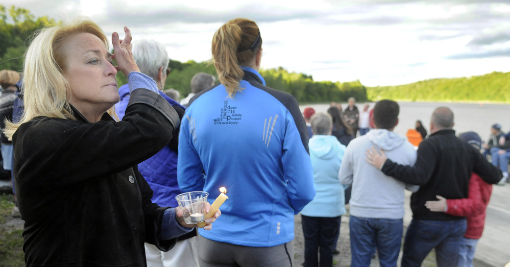 Jane Lincoln holds a candle Monday during a memorial service in Hallowell for victims of the shooting in Orlando. Lincoln served as Chief of Staff for Gov. John Baldacci.