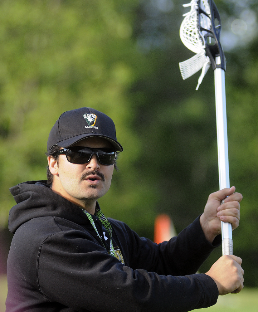 Winthrop/Maranacook lacrosse coach Zach Stewart demonstrates a drill at practice Monday in Readfield.