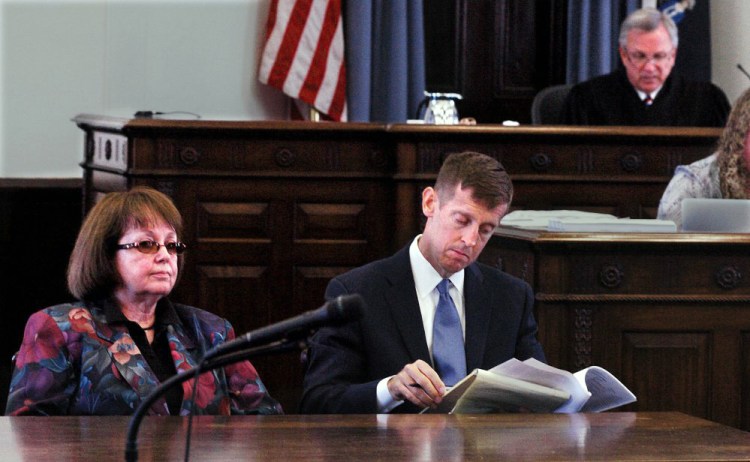 Claudia Viles and her attorney, Walter McKee, listen as Justice Robert Mullen gives instructions to potential jurors Wednesday in Somerset County Superior Court in Skowhegan.