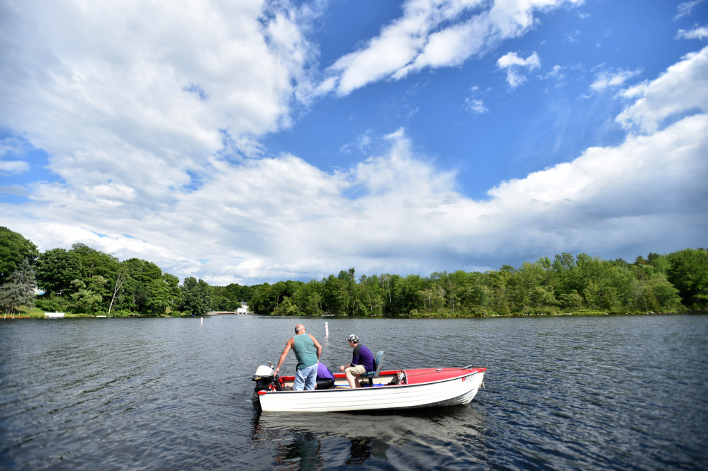 Ron Cunningham heads out on Mesaalonskee Lake on Thursday from the boat launch at the Oakland town beach with his sons Scott and David. The town's Gazebo Committee is moving forward with an effort to erect a gazebo near the boat launch.