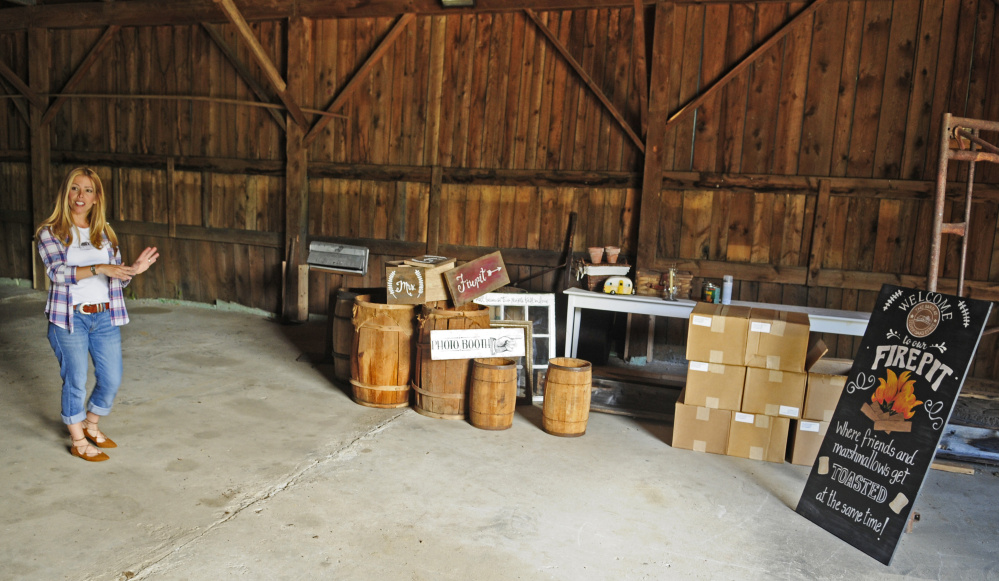 Veronica Carbona talks about signs and the venue during a tour Thursday at the Barn at Silver Oaks Estate in Winthrop.