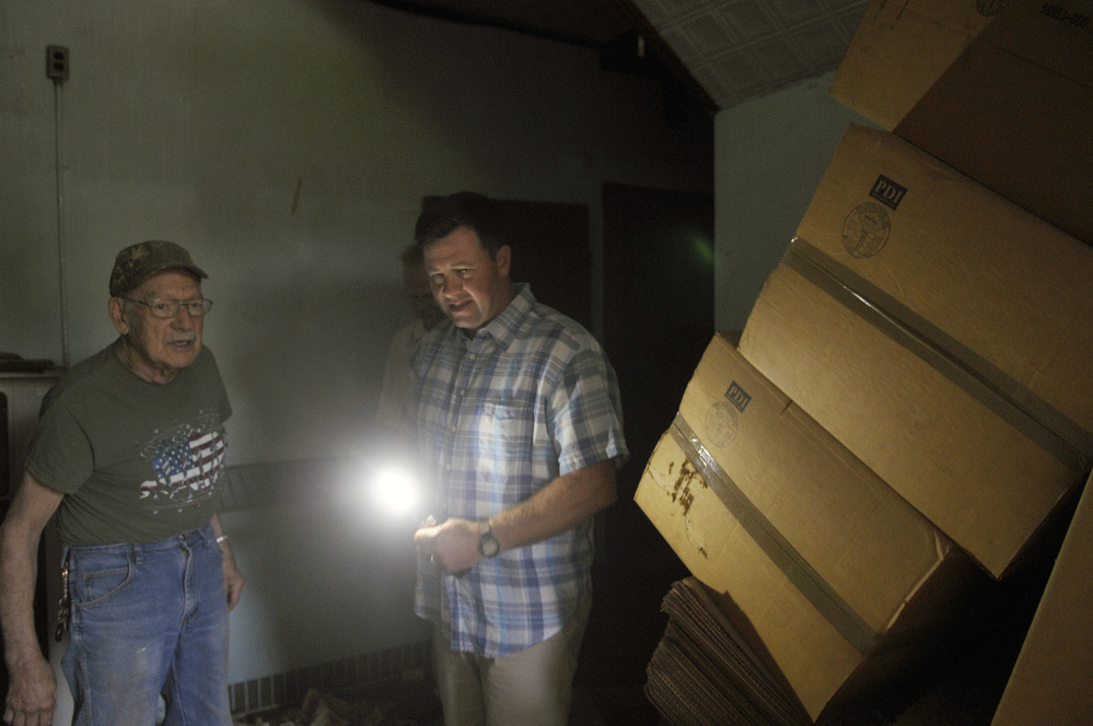 Matt Morrill, right, guides Burt Truman through a building at the Stevens School Complex in Hallowell Monday. Morrill recently purchased the dilapidated former correctional facility and state office complex.