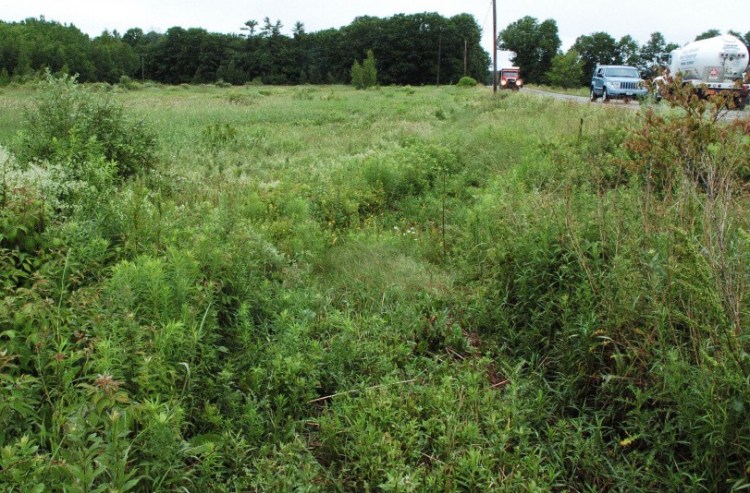 Traffic on Wednesday along Route 32 in South China passes a field at the Three Level Farm property where a proposed community solar farm will be built.