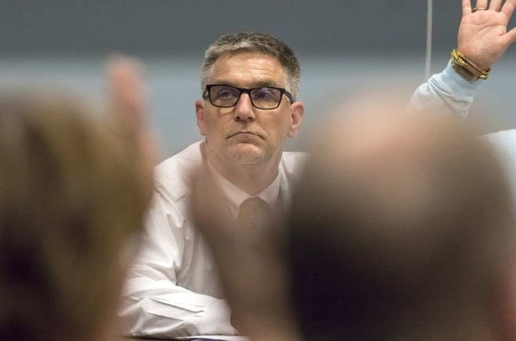 Then-Superintendent Frank Sherburne scans the SAD 6 board last month as it votes to accept the summary of an investigation into the hiring of his son as an education technician.