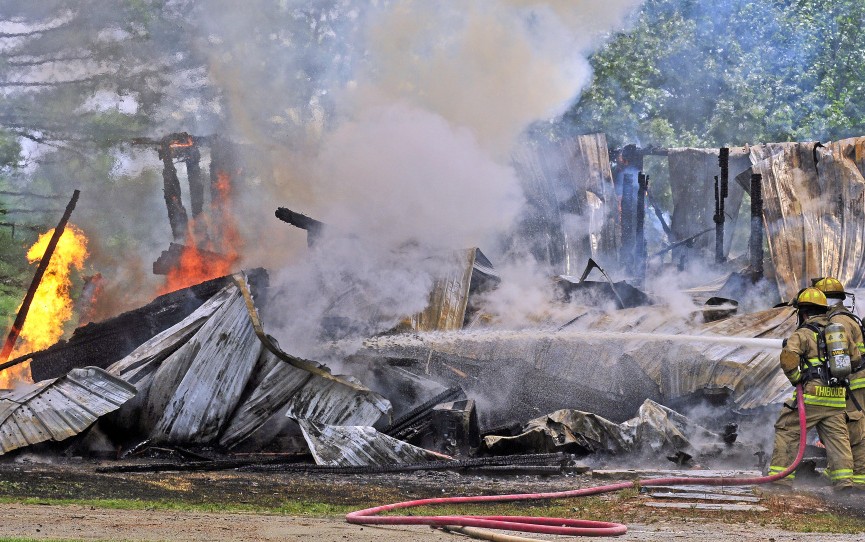 Firefighters battle a blaze Sunday at 35 Holway Road in Sidney.