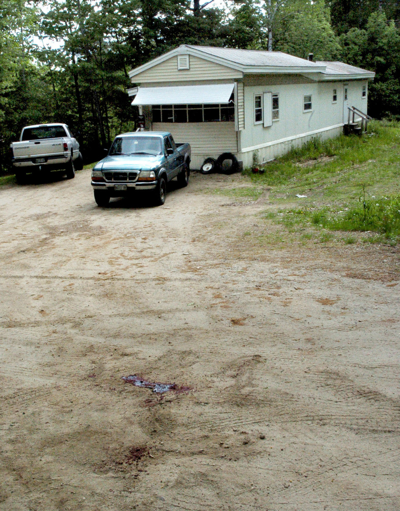 A pool of blood marks a driveway at 259 Weld Road in Wilton, where Michael Reis of New Sharon was killed June 1.