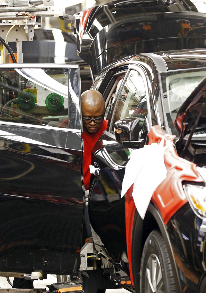 A technician works on a door assembly for a Nissan Altima on the assembly line at the Nissan Canton Vehicle Assembly Plant in Canton, Miss., in April. On Thursday, major U.S. automakers reported sales figures for August had declined overall from one year ago.