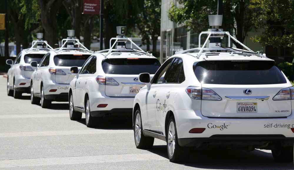 Google self-driving cars are parked outside the Computer History Museum in Mountain View, Calif.