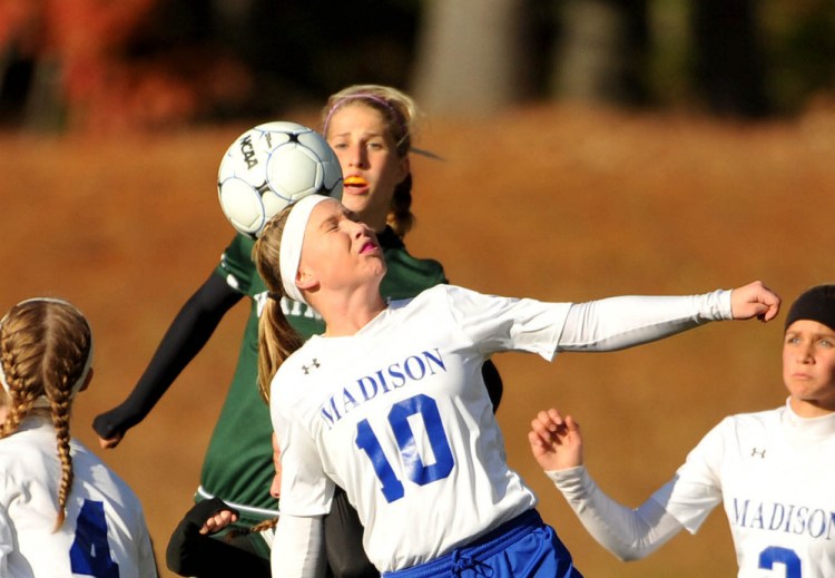 Madison midfielder Madeline Wood heads the ball during a Class C South playoff game against Waynflete last season. Wood returns to help lead a dangerous Madison team this fall.