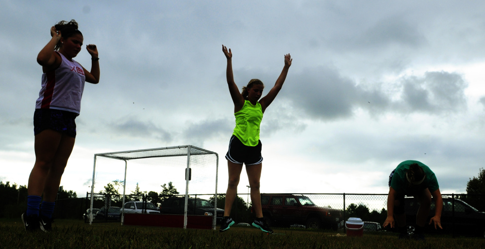 Cony High field hockey players stretch during an Aug. 17 practice in Augusta.