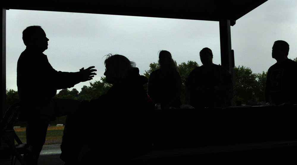 Dr. Michael Dufresne, left, speaks during The Addict's Mom Light of Hope event Saturday in Mill Park in Augusta.