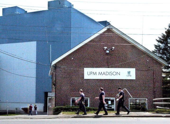 Mill workers carry tools into the Madison Paper Industries mill in Madison in May. The assessment of Madison Paper Instrusties property in Madison has dropped, but in Anson it has risen, largely because its hydro plant hasn't been reassessed in 10 years, and the company is asking the town for an abatement.